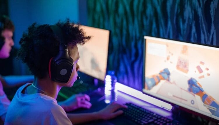 Teen gamers engrossed in online computer game in a vibrant, modern gaming room., tags: sjokz über - pexel