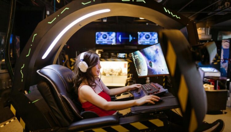 A woman plays a video game in a high-tech scorpion gaming chair, immersed in a modern arcade., tags: die esports ein - pexel