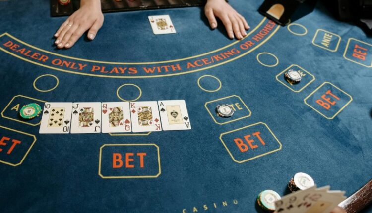 A casino gaming table featuring poker cards and chips, showcasing a vibrant gambling scene., tags: betmgm uk spieler - pexel