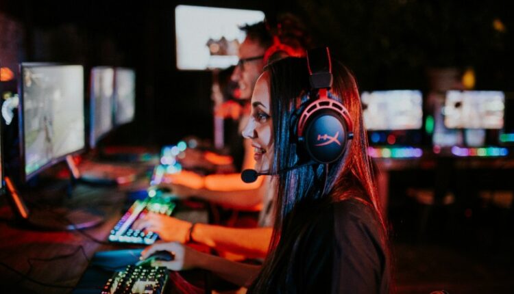 People enjoying a late-night video gaming session with headsets and RGB keyboards., tags: gaming-markt 2024 - pexel