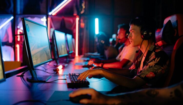 Group of gamers immersed in competitive esports at a cyber arena with neon lighting., tags: versteckte - pexel