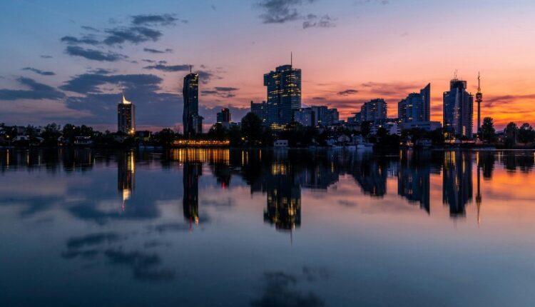 Tranquil reflection of Vienna's cityscape at sunset, showcasing serene waters and vibrant skies., tags: österreichs online-casinomarkt vor - pexel